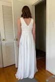 I bought a M to try on for a wedding dress option for my wedding in Greece later this year. It's a very nice dress and fits well, especially if you are tall - I will probably have to hem it even though I'm 5'10", since I'm not wearing heels. I'm going to need to take in the waist a little to make it look a little more shapely on me, since the waistband is a bit loose on my body. I'm also going to adjust the underskirt so that the slit doesn't end up showing quite so much leg (you can see in the attached picture that the underskirt slit ends slightly higher than the outerskirt slit. These are manageable adjustments - my biggest issues is that the material is see-through enough that the bodice ends up showing that overlapping triangle in the front, which I don't like. I didn't see this in the consumer pictures when I bought it because it depends on your bust size and what color dress you buy. - Marina B.
