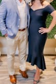 The dress fit like a glove. I ordered both the L and XL and XL fit better.  The navy was very nice and could be used for a formal event or date night. The only annoying thing was the little straps that help hang the dress, I ended up cutting them off because there was nowhere to hide them with the shoulder-less style (they kept creeping out of the back or arm area. Now I don't have a great way to hang the dress but oh well.  All in all great dress for the price! - Christina T.