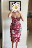 I like this dress a lot. The ruching is really flattering. I may have torn it some how because the boning is stabbing me under the arms (kind of like a bra where the underwire is poking out) very painful but if I pull it a certain way it doesn't stab as much. It has a good amount of stretch. Just be careful when trying it on! - Mary E.
