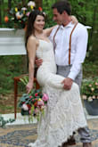 I adored this dress! It fit my needs perfectly. I didn't want to spend a lot on a gown, our wedding was in the woods and I knew it would be destroyed by the end of the night.. I had to have it shortened, and I changed out the straps so they wouldn't be adjustable. It was stunning in photos! It did have a hole in the lace around the seam where it mermaids out by the end of the night, but I didn't plan on ever wearing it again, so who cares, right? - Megan M.