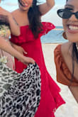 The dress runs small. I am normally a L, but had to get an XL. I actually bought this dress in multiple sizes to make sure I got the right fit. I wore this dress to a Mexico beach wedding with red lipstick. In the right size, this dress is flattering for those who do not want a form-fitting dress. - Charlene T.
