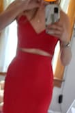 Material is fantastic-it is form fitting but also has a give to it. Hugs in all the right places. The color is the perfect true red. I love the fact I can pull the bottom down a bit if I wanted to show some extra skin, or pull it up to be a tad more conservative. (See photos) Can't wait to wear it to an upcoming party. - Melissa A.