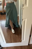 Originally bought a SM but it had a bit too much give in the hips and was too long, so exchanged for the XS, which is a better fit. It's still a little long but that's how it goes when you're 4'11''...pairing with tall heels should help, and since it has a TON of fabric, I might actually gather up some of it and tuck it into the waistband for a more casual look. As others have said, there isn't stretch in the waist band, and I worried it would be too tight, but it actually fits pretty well and isn't constricting. Color is lovely and true. Feels very breezy. Don't mind wrinkles in pic, haven't steamed it yet. - Suzanne F.