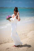 This dress has a stretchy material. I could have ordered an xs but I ended up keeping the small and having it altered. It was perfect for my beach wedding. Very elegant and classy. Very flattering dress. Had it altered to be a little more mermaid shaped and turned out beautifully. - Andrea U.