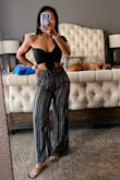 I could have gone XS but the S fit fine. I'm always looking for unique cuts and stand-out tops. This is definitely one! Especially being in black, it will match a ton. - April C.