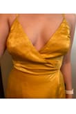 The only thing I liked about the dress was the shiny fabric. However, the dress was weirdly made and it doesn't look flattering like the pictures. It runs large except for the waist, the waist is very very tight, you can hardly breathe. There's extra fabric hanging off the chest, you need to keep pulling up the straps and it looks unflattering. 
I returned it because it would have needed several adjustments and it didn't justify the price for how it was made. Lastly, it feels heavy and there's a lot of fabric hanging. It might be hot for a summer day. - Samanta L.