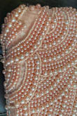 When I unwrapped it from the packaging there were a couple of loose pearls. I hung it up for my daughter to take to her formal. The day of formal, we realized the pearls had been dropping off the purse on the hanger for days. Never worn once, but looked terrible for her formal. - Maryclaire A.