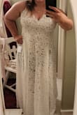 I absolutely LOVE this dress! I did have the straps shortened because the dress hung too low, however, after taking several inches off those, it seriously is perfect. It fits beautifully and sits beautifully. Not too snug. I am wearing shorts in the photos, as I was only trying it on, however, there is a body suit. I did purchase a sort of Spanx to wear because the bodysuit is a little snug and doesn't cover all of what I'd like it to, but that's not really that big of a deal. Overall, I'd highly recommend this dress. Some people were leery and I was nervous about it, mostly because it was an online purchase, however, the reviews were amazing and I love that they had a model that was more my size than was in the photos, it really helped determine my final decision. It is floor length (on me) and will show off my shoes beautifully as well. I cannot wait to wear this for our big day!! - Kristen P.