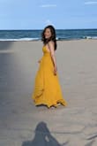 LOVED THIS DRESS!! Beautiful elegant dress word at a beach wedding,  stunning dress , turned heads all night,  loved the flow of all the fabric in the wind. Good quality fabric. On both sides shows shows a little bit boobs but nothing inappropriate. I usually wear size small and I'm usually a size 4 but I bought a medium based on the feedback and I am glad I did! Fit perfectly. :)
It is very long and that makes it even more elegant I did not wanna to Hemet in but I did have to grab it all night from underneath my own feet ha ha. - Susan S.