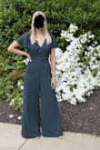 Loved this jumpsuit! It was absolutely perfect for a ceremony I went to. It fits true to size but the pants are long. I am 5'5" and had to wear heels so the bottom wasn't dragging on the floor. The open back was a nice touch but I think I would have liked it more without. You have to be careful about leaning over because the front will become loose from the open back. However, I still rate this a 10/10 and would recommend to anyone who was looking for a cute jumpsuit!! - Brooke H.