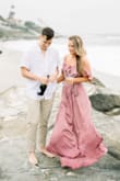 The dress looks stunning in person and is very flattering. It was a little long on me since I wore it on the beach without shoes. I think it would be perfect with heels. I ordered both a M and L to try and the Medium was plenty big. I love how the dress looks in my engagement photos! - Kristie K.