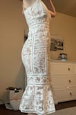 This dress is so pretty and unique! The detailing is lovely. It is quite fitted throughout the hips and legs but a little looser on the top. I would size down if you have a smaller chest, but be careful because there is no stretch in the thigh area! - Tenley J.