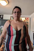 I ordered an XL according to their size finder. I could barely pull it over my breasts - with AND without a bra. It hugs me in an unflattering way, and I couldn't zip the side zipper. You can see in the picture that my boobs are just smashed. And it's not due to my posture. I tried standing in different ways, and nothing changed. I am very disappointed that this dress didn't work, and it makes me hesitate to buy anything else from this site if this is how the sizing is. - Melissa C.