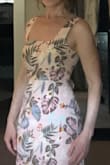 I'm 5'4" 119 lbs, always a reliable size 4 and this dress in a size Small fits like it was made for me. I have a smallish chest and full butt; I'm wearing the Soma Ultralite lift strapless, backless bra underneath. It works well. The dress has a built-in short (mid-thigh) slip underneath. The fabric and pattern are nice. I find this dress very figure flattering, shows off my waist and is sexy yet modest at the same time. The hem hits me at mid-calf. - Denise M.