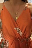 I sized down according to the reviews and the XS fits perfectly. I am usually in between a size small and a medium and while the small would work, the XS looked better. I ordered 3 of these dresses- two in blue (Small and XS) and one orange (XS). I only kept the XS blue. It is a little long but with a heeled shoe, the length is fine.

I ended up returning the orange dress because the print design was barely present on the top of the dress. However, the inside of the top would have been beautiful if it was on the outside. I wish there was better quality control with this. It almost looks like they sewed the top of the dress inside out. - Kristin C.