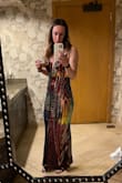 I loved this dress and it was definitely an eye catcher! I went with the small size in the dress and I thought it fit me (and my large traps)perfectly. I will say I don't have large breasts at all and I needed to put some cups in the top to fill it out so it didn't sag. - Chelsea R.
