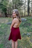 This dress was stunning on my 14 y/o for her first semi formal! We probably could have used an XS as it was big through the back but gave room in the belly to eat middle school junk food! We ended up pulling the straps across to make an xtra X and stitched it. Solved the loose back. The material was far superior than we expected and the color was gorgeous ~ deep red wine almost. Kept its shape all night and looked adorable with low rise converse but could be dressed up with heels easily! Used adhesive gel backless bra for a bit more support as she is in between a B and C. Highly recommend!! - Shannon G.