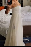This dress looked a little plain when I saw it, but when I tried it on, it was gorgeous. It made me feel like a princess. It has weight to it and feels really high quality. The material is super nice. I love the bustier part that pushes my girls up and hugs them just right, no bra needed (even though I normally can never get away with not wearing a bra). I'm usually worried about my tummy and that wasn't an issue at all... it was so flattering! It's my favorite and I ended up buying another one in blush! - Lany K.