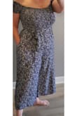 Super cute jumpsuit.  I don't normally like jumpsuits but this one has changed my mind. Big plus is it has pockets. The top fits well because it is all elastic so it hugs where it needs to, not too tight and not too loose, gives when it needs to, and I don't need to wear a bra. The little sleeves are also elastic and stay in place and are not too tight or too loose either. I have big hips and heavy legs so I was happy that this jumpsuit has lots of leg room and the length is pretty much perfect. There is a matching tie belt, I prefer to wear the tie a little on the side rather than the center front. I always seem to get a lot of compliments when I wear this and it's really comfortable. Note, it does shrink a little in the wash. - LISA N.