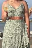 Purchased this impulsively for a vacation! I liked the pattern a lot and the color seemed Ref-inspired to me. I didn't quite fill out the cups but there was no gaping and I never flashed anyone. The skirt is comfy, ties nicely, and can be adjusted. It had a cute slit in the sides that stayed when I was standing but almost revealed my underwear when the wind blew! Maybe I tied the skirt wrong. Can't wait to wear this again! - Alexandra B.
