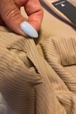 Showed up with a very clean slit on one side by the hip. At first, I thought it was a pocket but it is a rip. Also has loose threads.  Not the best quality I'm used to.  When I purchased it said exchanges only but when I went to try to exchange it, now it says no exchanges. Disappointing to say the least! - Jacqueline O.