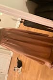Comfy fit. I also purchased this skirt in a xs. Both fit fine but this skirt in a sm allows a little wiggle room if I gain some weight. The xs not so much lol. Beautiful and flowy. Very feminine. My cat in the background approves - Sally M.