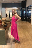 This dress is beautiful- feminine and flowy, comfortable and such a beautiful bright pink. I bought a medium and probably could have worn a small as well since there is plenty of room. I received a lot of compliments and I believe it's a very flattering cut. - Suzette C.