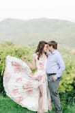 I loved this dress!!! It was dramatic and stunning and perfect for my engagement photos! It is a true wrap dress so it really can fit anyone of any size. I did have to get it hemmed but I wore flats with it. - Katie W.