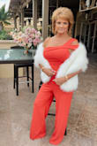 I ordered this darling jumpsuit for a wedding in SoCal. It is such a vibrant red, super fun & sassy! Take note that it is really long and I had to have it hemmed. But I truly loved it and got SO MANY compliments all night. I am 57 yrs old and this cute piece made me feel 35 again! Paired with the Ivory Faux Fur Stole and felt like a Princess. Thanks, Lulus, I'll definitely be ordering from you again! - Lisa N.