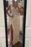I was a little nervous about ordering this one online, but it did not disappoint! The dress is lined with a thicker nude-colored underlining and the lace on the outside is a softer lace material, so it is not stiff. I think it would fit perfectly (me personally) with a little tailoring around the waist. Because of my height and shoulders, a medium is perfect otherwise. Loved the combination of modesty and sexiness with this dress! Would pair nicely with a diamond or pearl sash- but is not necessary because it is beautiful as is! - Candace C.
