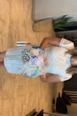 I wore this dress for my rehearsal dinner and received a lot of compliments on it and the design! I love that I had a little extra sparkle to it. I didn't want it formfitting so I went with the large and it fits me perfectly and in length as well as I'm tall. I did have to pull it up a tad when I sat down but it was fine. - Christy N.