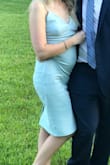 When I first tried it on I loved it, it was sexy and straight. Wore it to a wedding and I quickly realized that as I moved it bunched around the waist... a lot. I kept having to bring it down. I don't think I have a decent picture without looking wrinkled or pregnant. Not flattering at all. :( - Alexandra B.