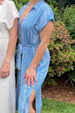 This dress is great! Lightweight dries easily if your kid splashes on you :). The fit is roomy-- I sized down based on previous reviews and I'm glad I did. The first button is pretty low, so if you are more modest or busty you might want a cami, but I was fine as is. - Kelly W.