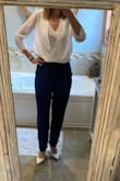 This was my first purchase of paper bag style pants and first purchase from Lulus and I was pleasantly surprised!  I bought a small based on the models info.  Fits great and the waist and through the legs but is definitely not a cropped pant. Still looks good with heels and super comfy - Rachel S.