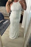 I bought 2 dresses from here and thought the other was going to be hands down the winner but once I put this on, wow!! The quality is great and it came with its own garment bag. The shape is very flattering. I was worried the pattern was too much based on other review photos but it is not overwhelming. I ordered a size L as I have broad shoulders and the midriff is a little loose. I wear Medium (sometimes S) usually but found in this brand if I don't get a L it won't zip above my waist. Better to be loose in the middle than not zip all the way. - Gillian H.