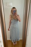 Ordered a small. It looked so cute for a baby shower and family photos. The straps are not adjustable and we're pretty loose/kept falling down, especially when sitting. Probably could have ordered a smaller size because of this or had them taken in. Loved the length and fit everywhere else. - Erika B.