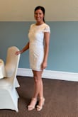 Such a pretty dress! The beading and neckline give it a classic and elegant look, while the length gives it just a hint of sexy. Fit perfect and got a ton of compliments. Wore to my bridal shower but also plan on bringing it on my honeymoon. Get the dress! - Alyssa T.