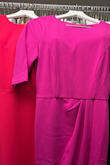 I love this dress. It fits well and looks very classy. My only complaint is the color. It's pink-fuchsia. It looks bright hot pink in the photo, which is what I wanted for an event. I decided to keep it because I can wear it to the office or for another occasion.
The photo shows the dress next to a hot pink CK dress. - Tracey C.