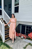 This dress was a lightweight silky material. I went to a wedding and it was over 90 degrees so this was a good choice. I got a medium and it fit perfectly. The straps are adjustable, which is nice. I liked the slit as well. Kept me a bit cooler. - Jess H.