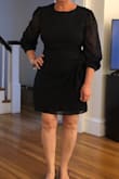 I love this dress! My only complaints are the zipper on the back bulges or puckers. )I ordered two sizes and they both did the same thing) Also the sleeves are VERY long, and I have long arms. I think I will just move the buttons on the sleeves a bit so they are tighter and fall at my wrist rather than to the middle of my hands. - Karen C.