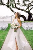 This dress is so simple, but perfect! The low back, front slit, and long train give it that wow factor. I love telling everyone I got my wedding dress for $100 too. - Brittany B.