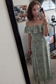 This dress looks so beautiful! It fits a little bigger than I would like but I think sizing down would be a little too tight. I'm going to get it hemmed so it's a little shorter but I expected that as I'm short! I'm wearing it to a wedding in September and I'm very excited! - Rachelle L.