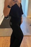 This jumpsuit is so cute and classy. Very stretchy material and comfortable. Had to hem it but that is expected as I am very short. Stays in place. I ordered XXS. It is a two person job to zip it. I could have gone a size up but the material is so stretchy I like how it stays in place - Julie J.
