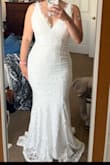 Love this dress, absolutely the perfect wedding dress. The material is slightly stretchy, so although still a bit tight I don't feel restricted. I can move and sit easily without worrying about the material being too tight or splitting. It is a little long but just enough to make a small train which I like, and not enough to worry about tripping. The lace on the neckline is also beautiful! Highly recommend it, no one believes me when I tell them it's $99, it looks and feels much more expensive. Perfect dress! - Cynthia G.