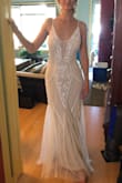 This dress fits true to size and has a lot of beautiful detail. The dress is well made, but a bit heavy (I think my shoulders would have felt it by the end of the night). This would be a very unique wedding dress, and if the shoulders were a bit more comfortable I would have definitely worn this on the big day. - Caroline D.