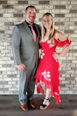 I wore this dress to a wedding. I have an athletic build with a pear/hourglass shape. Absolutely no stretch to this dress and it is very form-fitting. However, the dress moved beautifully and the color was so vibrant. I did not wear a bra with this and don't think there would have been room for one. I did use breast petals to ensure there was nothing showing. Overall this was a great dress. - Jenna B.