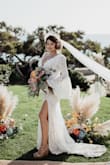Bought this dress for my rehearsal dinner/travel weeding photos, but ended up wearing it at my mini COVID ceremony. It was absolutely beautiful, fit like a glove, and minimal tailoring needed. I added on a simple button bustle for the train and sleeves. - Britni L.