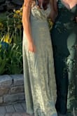 This dress is absolutely stunning! The fabric is super smooth and is so comfortable! The slit is at a perfect height and the dress has adjustable straps to fit your personal comfort. The material falls beautifully! I hemmed the dress by about 0.5 inches to make sure I could walk in the dress comfortably without stepping on it. I wore this dress to my cousin's wedding and was dancing for most of the night, and was worried it would rip, but there is not a tear on the dress, so the fabric is very durable! This dress was the perfect fit for me, the fabric feels like a dream, and I felt comfortable in it the whole night!! - Melina S.