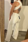 This jumpsuit is super flattering. The XS is a little tight, but it is not uncomfortable. It's made out of thicker material and feels nice to the touch. It's a little on the longer side and would look great with some heels. - Mila C.