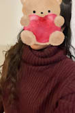 The color is beautiful. The neck part is a bit big and long so I have to fold it a few times but otherwise, I absolutely love it. It looks like a big comfy scarf around my neck instead of a turtleneck. I am very picky about my sweater yarns. The itchy yarns are very uncomfortable to wear.  This yarn is nice and soft and not at all itchy. The color is a maroon, more on the brown side. It looks brown in the pic due to the lighting in my room. - Nancy N.
